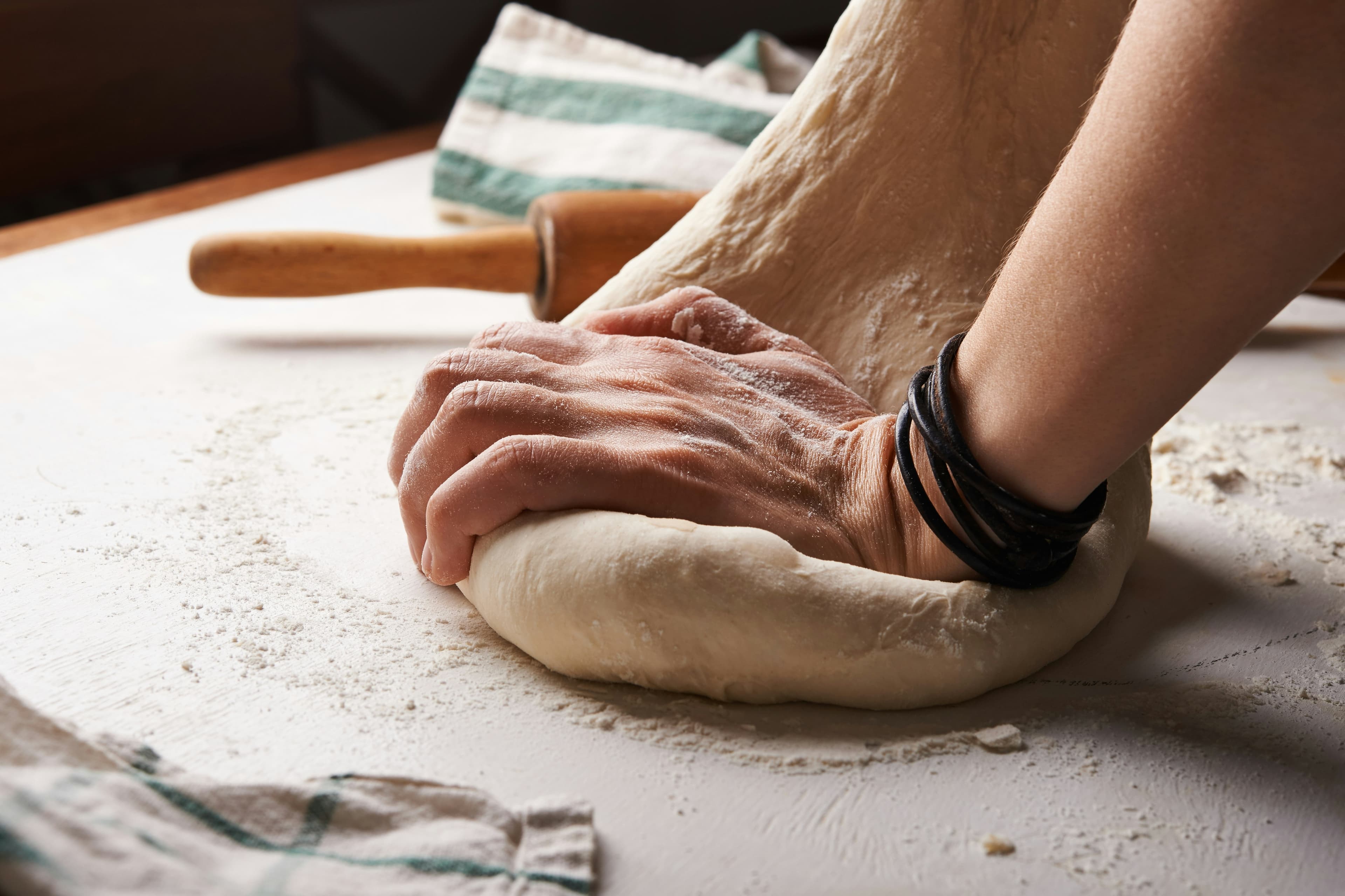 A baker kneading dough